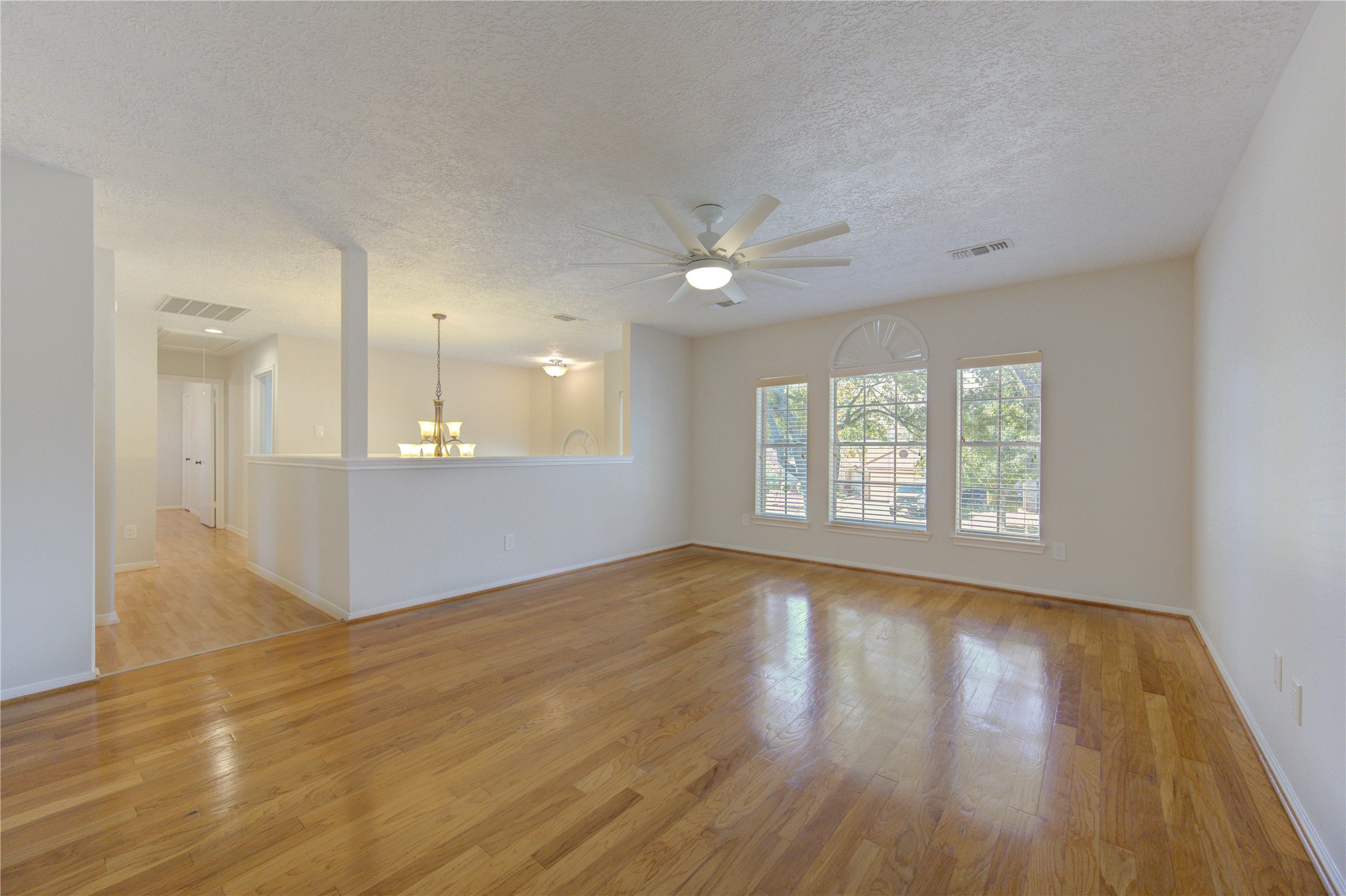 2518 Calvary Lane Katy, TX 77449 - Photo 18 of 26 a view of an empty room with window and wooden floor