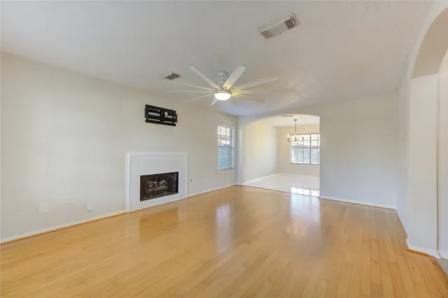 a view of an empty room with window and fireplace