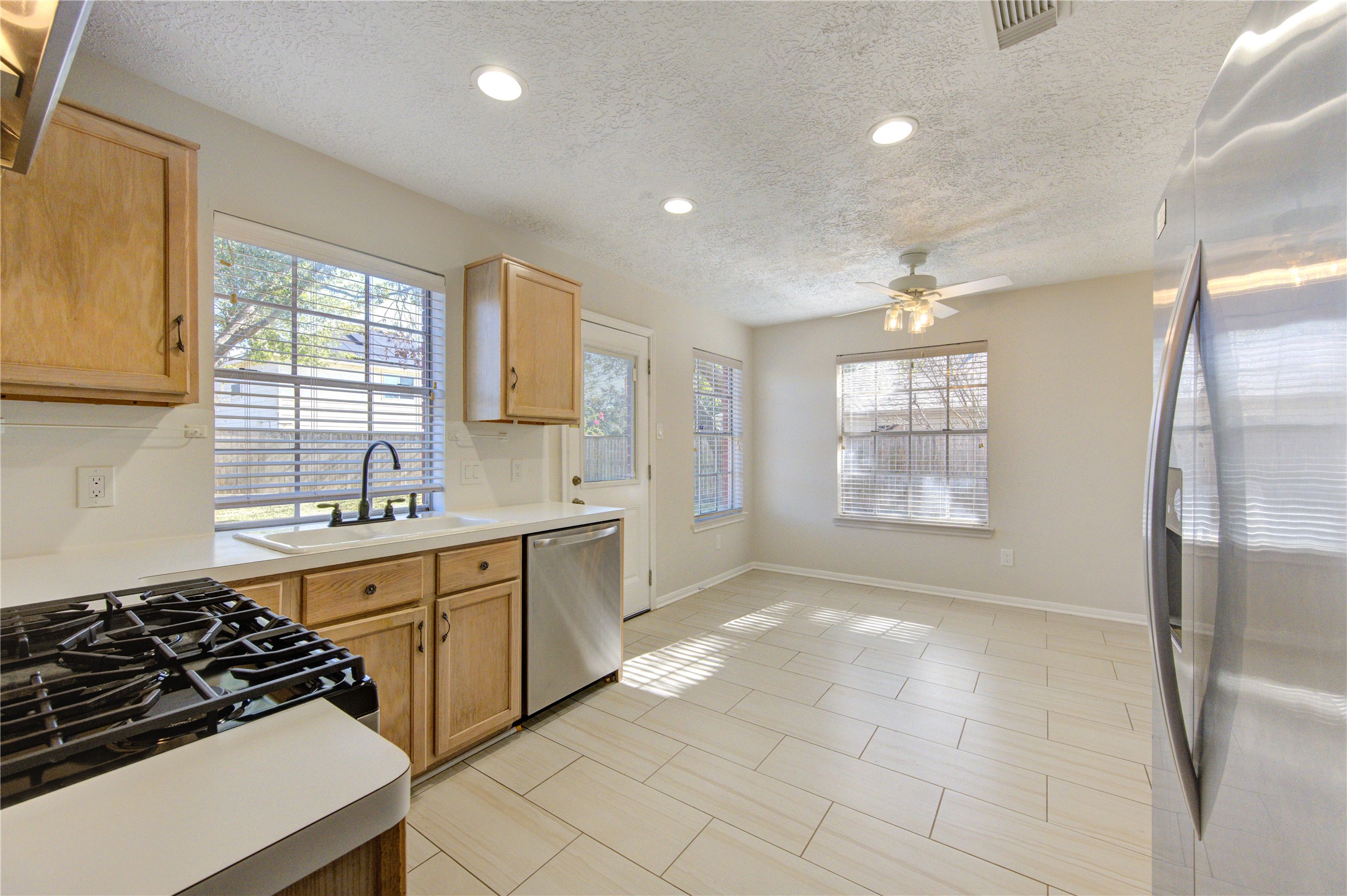 2518 Calvary Lane Katy, TX 77449 - Photo 9 of 26 a kitchen with stainless steel appliances a stove a sink and a refrigerator