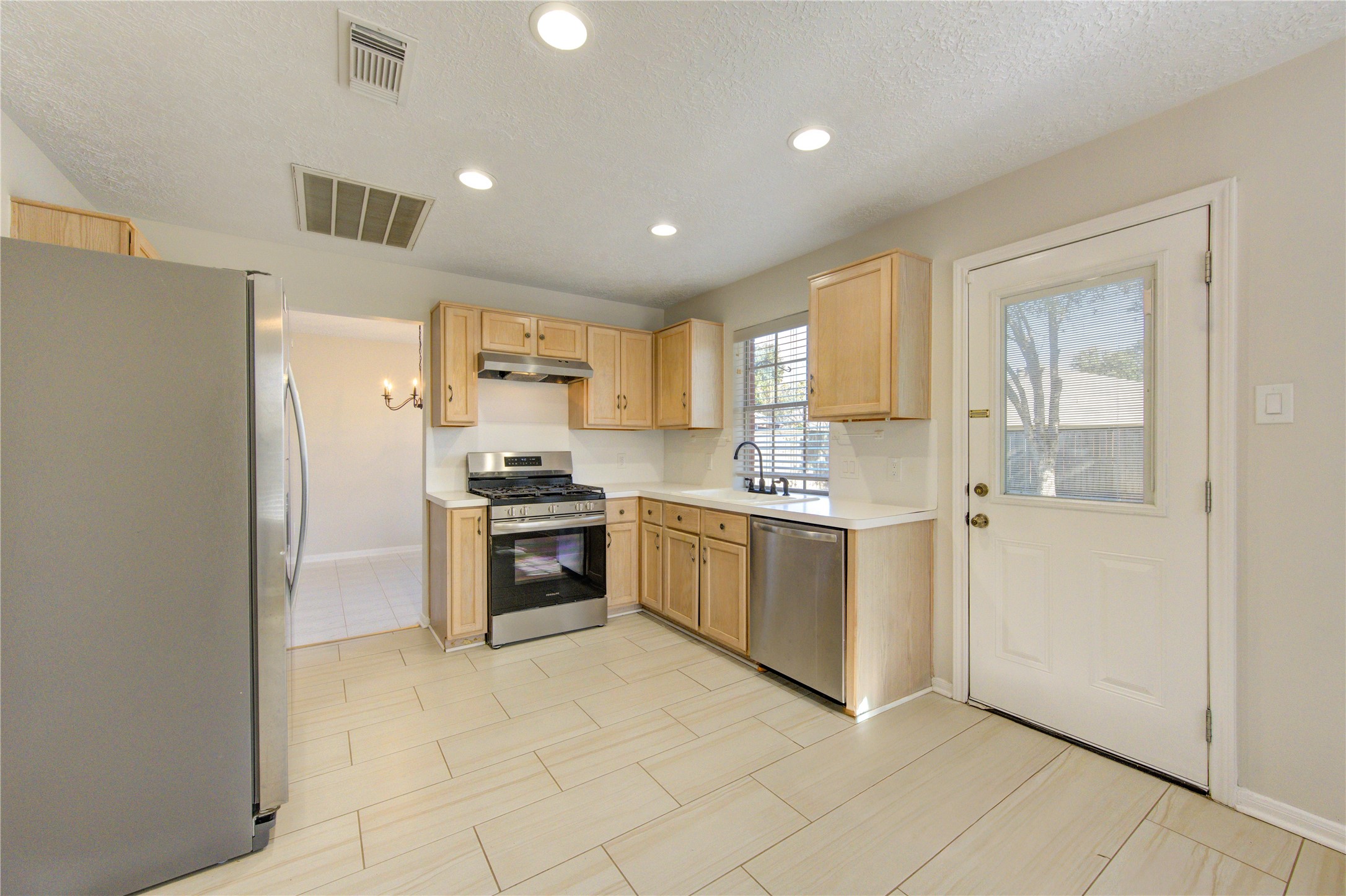 2518 Calvary Lane Katy, TX 77449 - Photo 10 of 26 a kitchen with a refrigerator and a stove top oven