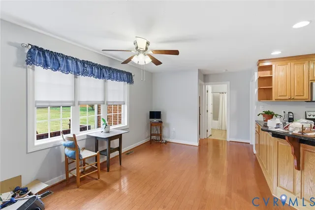 a view of a livingroom with workspace and a window