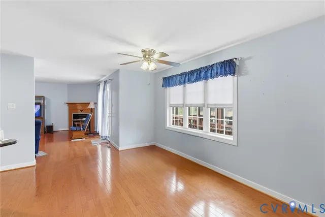 a view of livingroom with hardwood floor and a ceiling fan