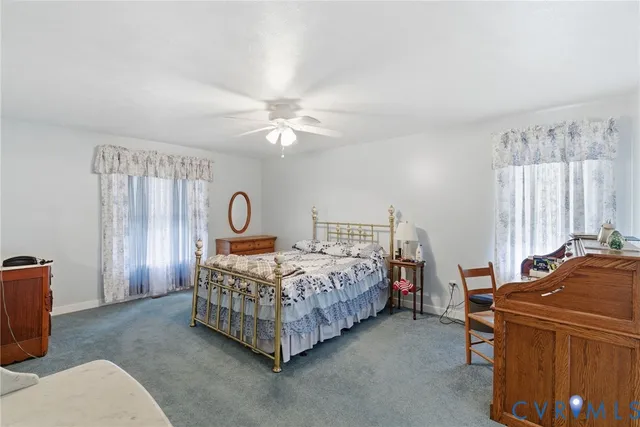 a bedroom with a bed window and a chandelier