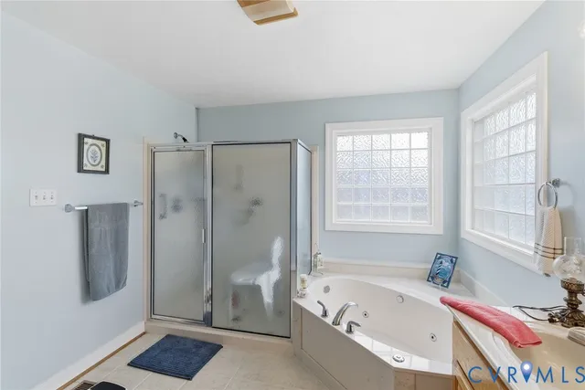 a bathroom with a tub shower and window
