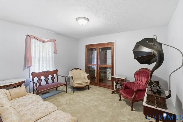 a living room with furniture and a mirror