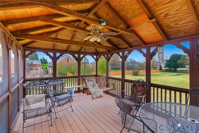 a view of porch with a table and chairs