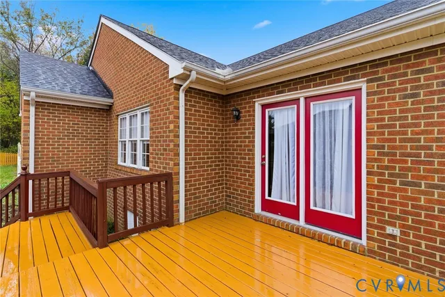 a view of a balcony with wooden floor and fence