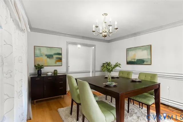 a view of a dining room with a table and chairs