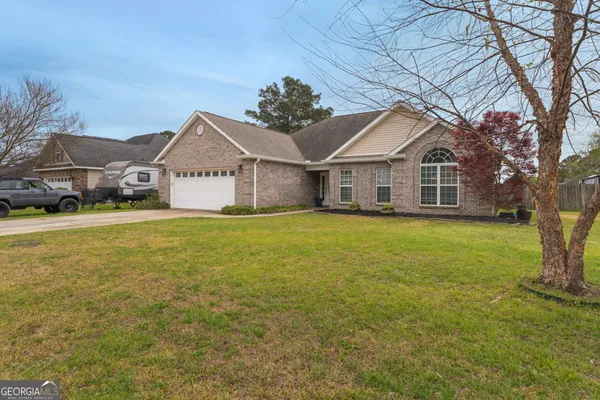 a front view of house with yard and green space