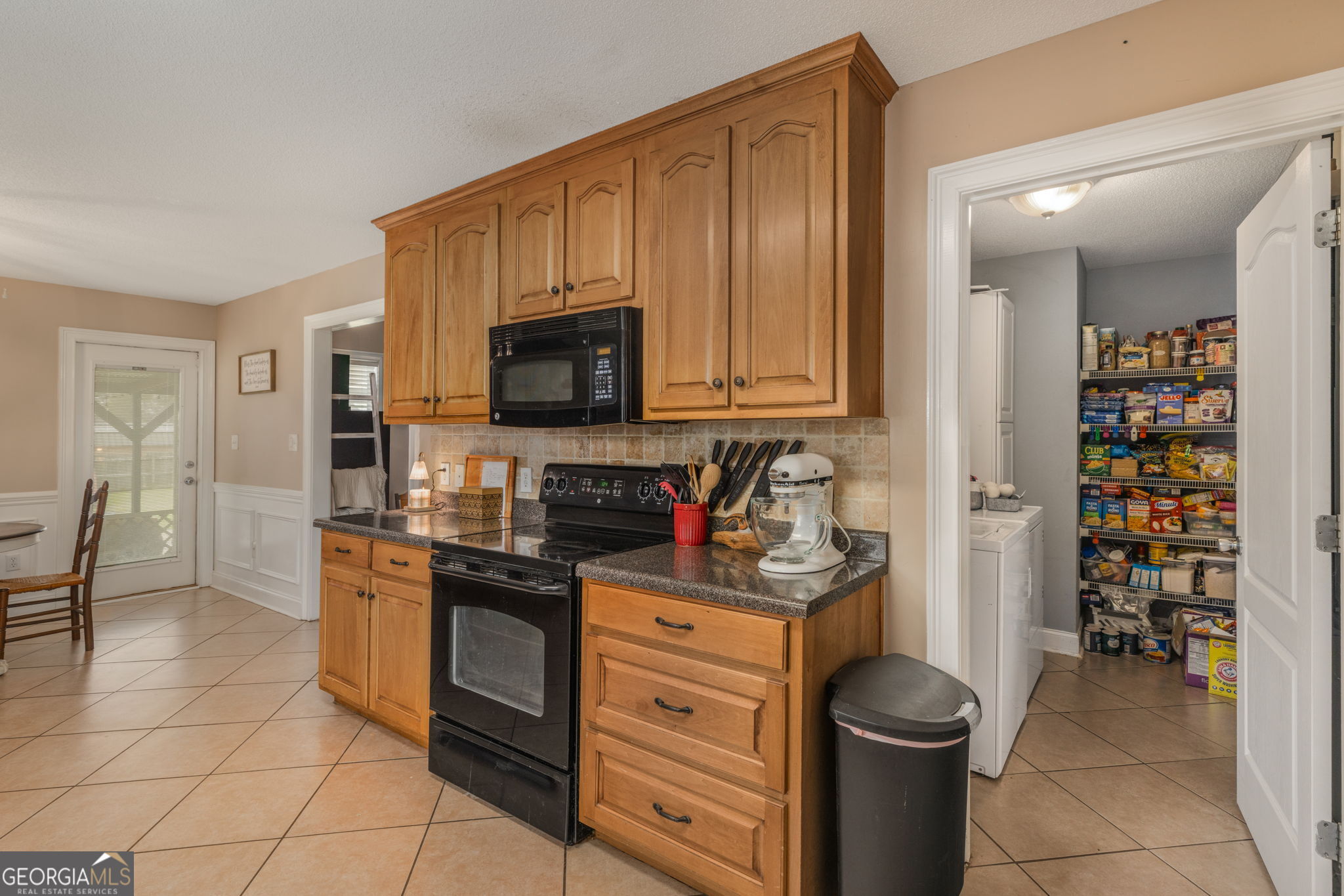 105 Galloway Street Kathleen, GA 31047 - Photo 11 of 35 a kitchen with stainless steel appliances a stove a sink and a refrigerator