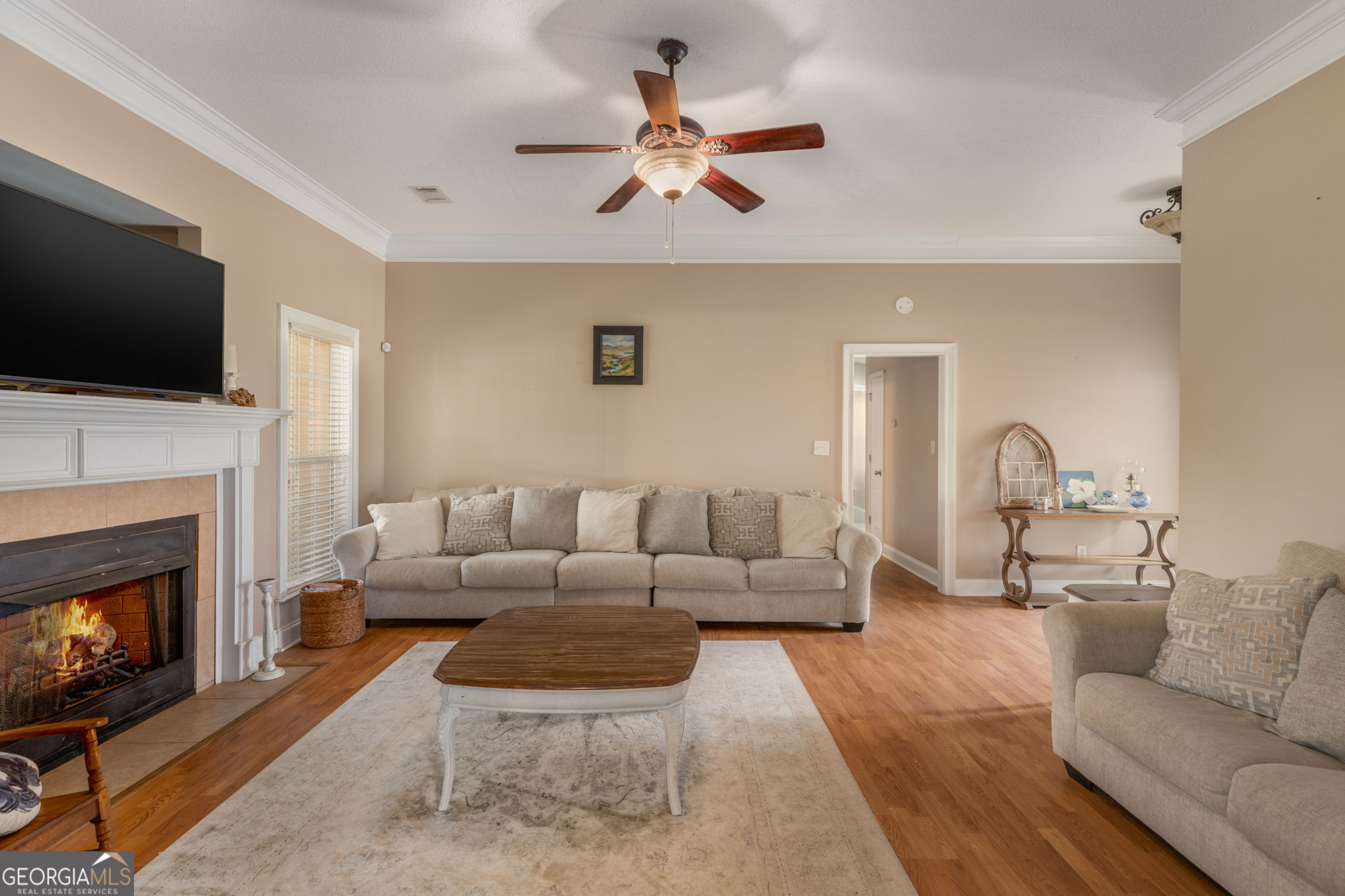 105 Galloway Street Kathleen, GA 31047 - Photo 13 of 35 a living room with furniture a flat screen tv and a fireplace