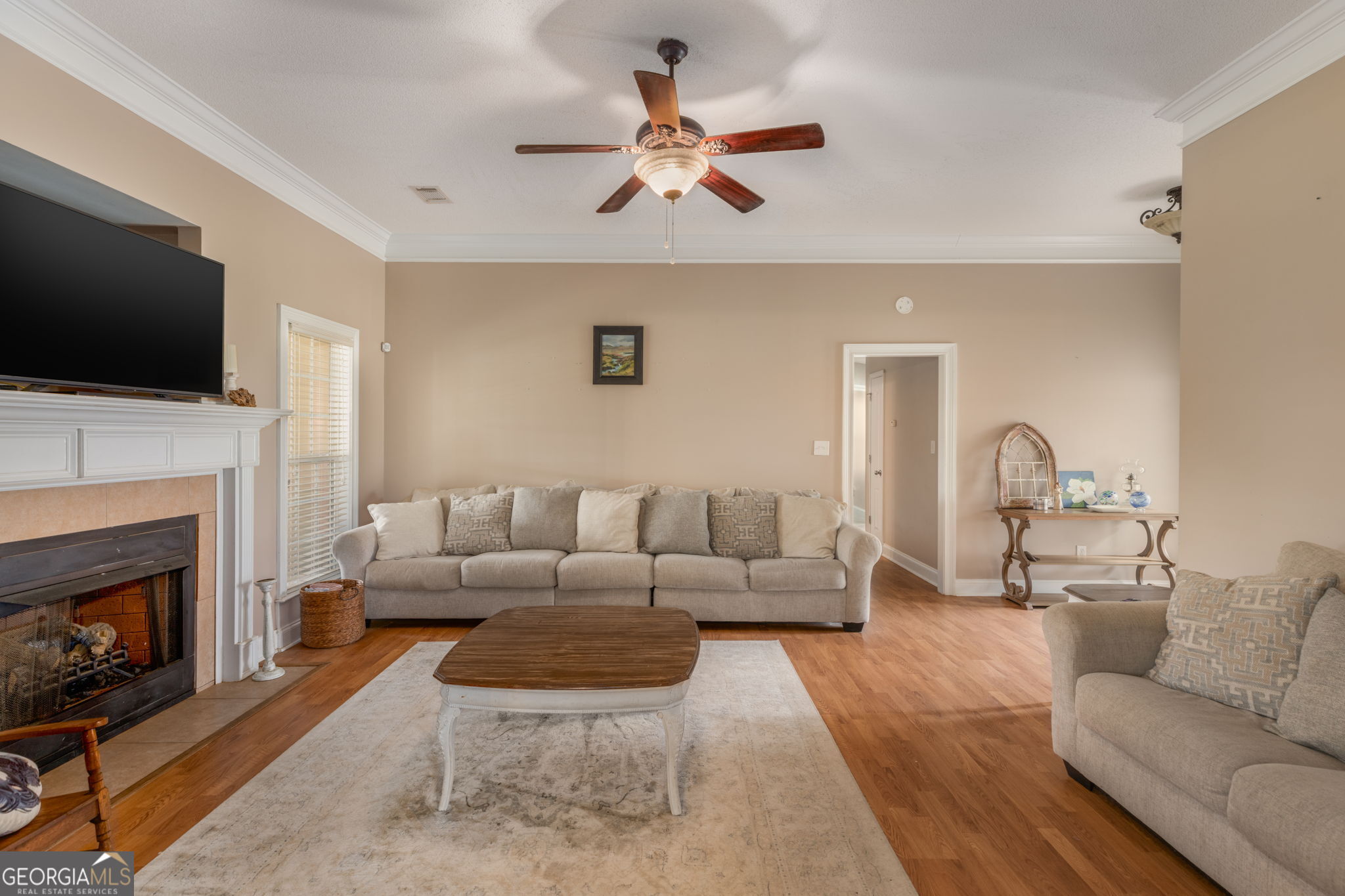 105 Galloway Street Kathleen, GA 31047 - Photo 14 of 35 a living room with furniture a flat screen tv and a fireplace