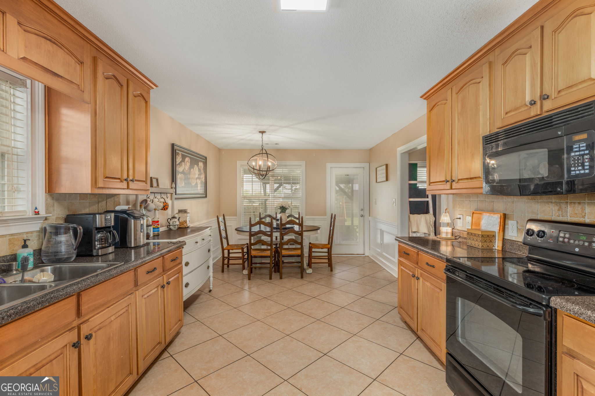 105 Galloway Street Kathleen, GA 31047 - Photo 16 of 35 a kitchen with stainless steel appliances a sink a stove top oven a counter space and cabinets