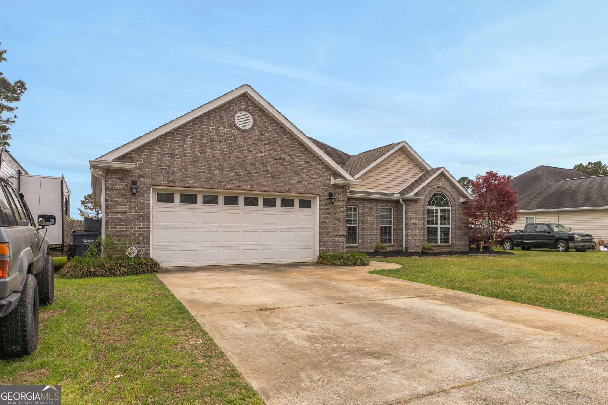 105 Galloway Street Kathleen, GA 31047 - Photo 2 of 35 a front view of a house with a yard and garage