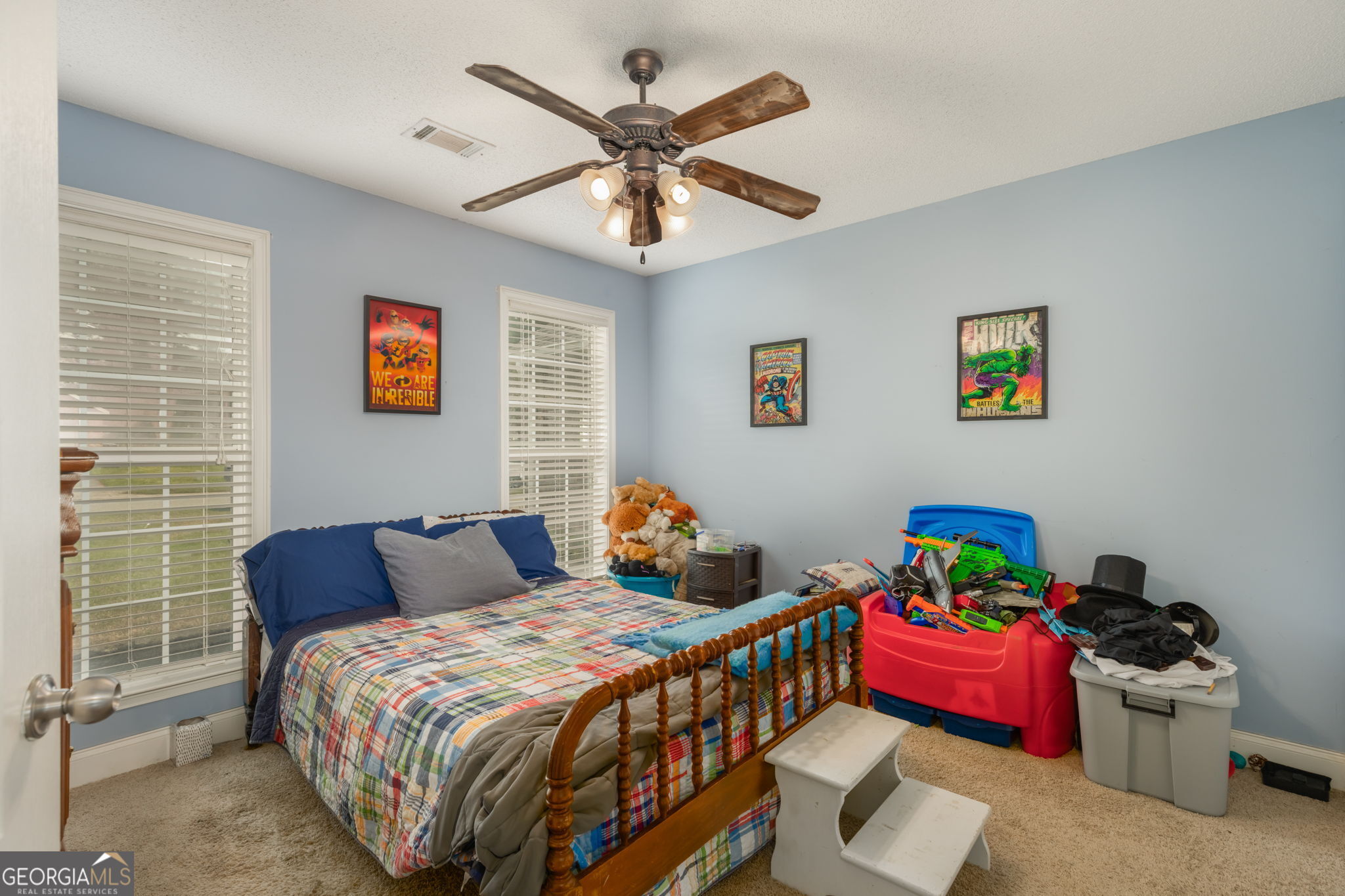 105 Galloway Street Kathleen, GA 31047 - Photo 23 of 35 a bedroom with a bed and a chandelier