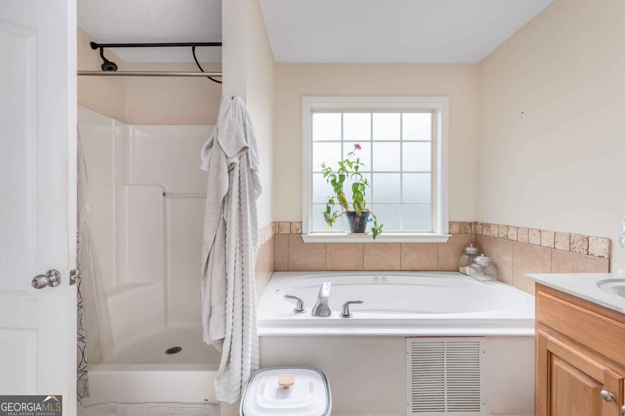 105 Galloway Street Kathleen, GA 31047 - Photo 34 of 35 a bathroom with a tub a sink and a window