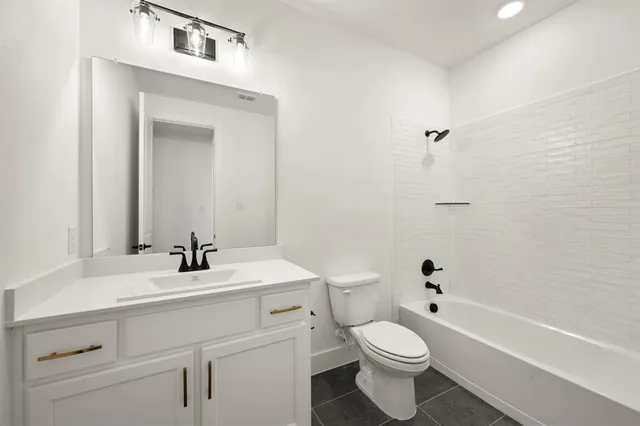a bathroom with a sink a toilet and a bathtub