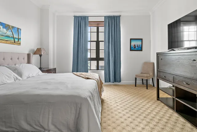 a bedroom with a bed and a television