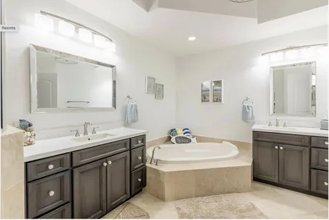 a bathroom with a sink double vanity and a mirror