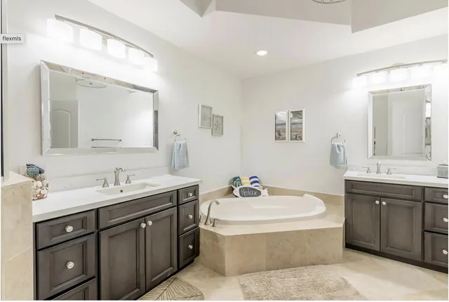 a bathroom with a sink double vanity and a mirror