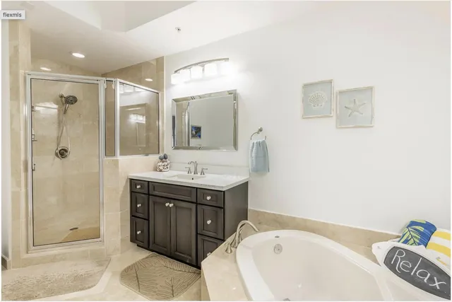 a bathroom with a tub sink and mirror