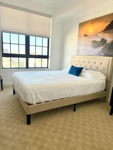 a bedroom with a bed and window