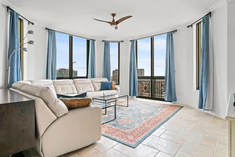 a living room with furniture and large windows