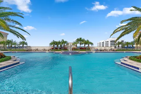 a front view of a house with a garden and trees