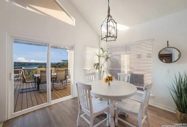 a view of a balcony with chairs and wooden floor