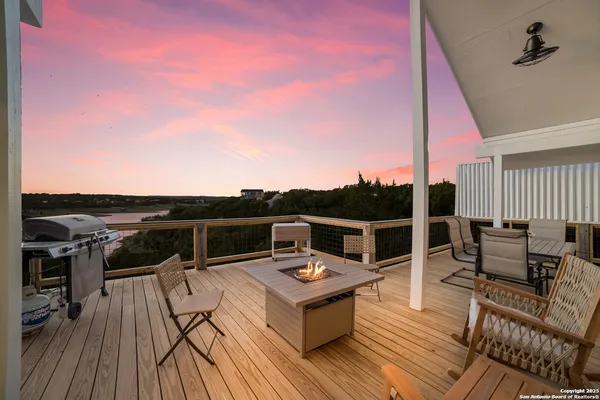 a view of a balcony with table and chairs
