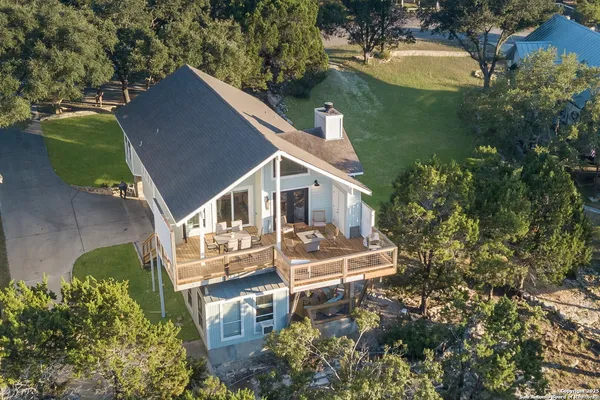 a front view of house with a garden and sitting area
