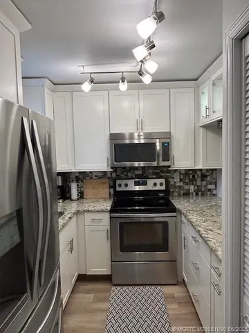 a kitchen with a stove and a refrigerator