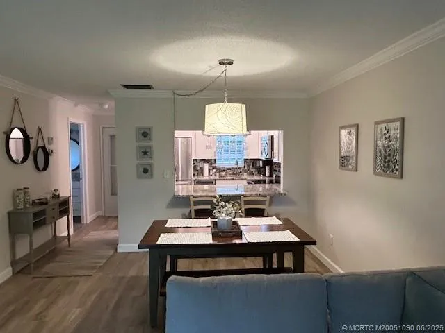 a view of a dining room with furniture and chandelier