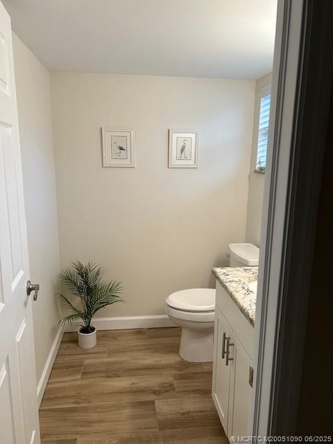 1909 Southwest Palm City Road, Unit D Stuart, FL 34994 - Photo 7 of 19 a bathroom with a toilet a sink and wooden floor