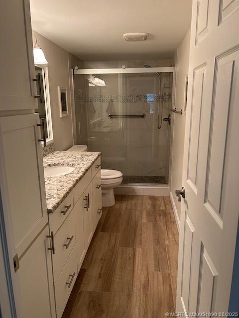 1909 Southwest Palm City Road, Unit D Stuart, FL 34994 - Photo 10 of 19 a bathroom with a granite countertop shower a sink and a toilet