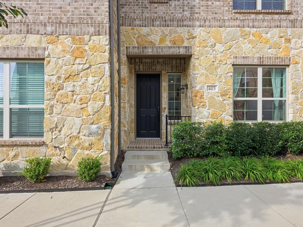 a front view of a brick house with a large windows