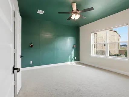 a view of a livingroom with a ceiling fan and window
