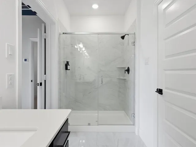 a bathroom with a shower and a bath tub