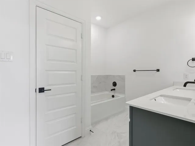a bathroom with a bathtub and a sink