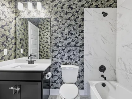 an empty room with windows and ceiling fan