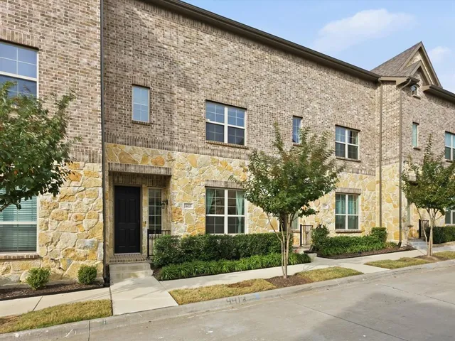 a view of a house with a patio and a yard