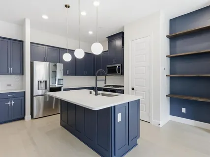 a kitchen with a sink a stove and a refrigerator