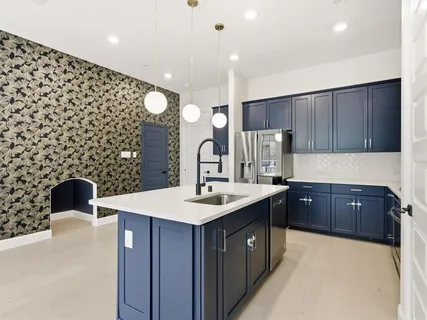 a kitchen with a sink and a refrigerator