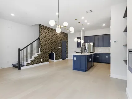 a large kitchen with a large island in the center and living room