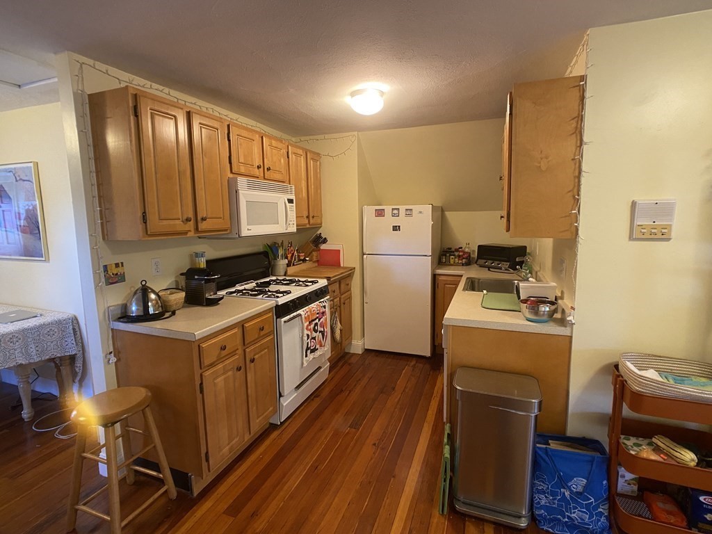 a kitchen with sink cabinets and wooden floor