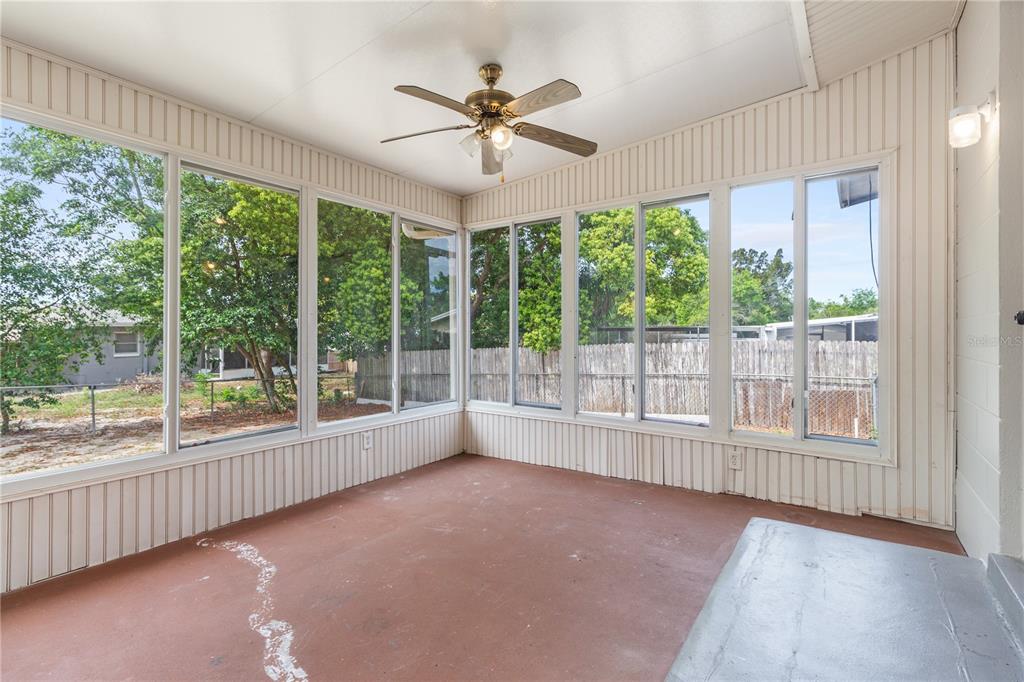 7208 Fair Oaks Street Spring Hill, FL 34606 - Photo 18 of 25 an empty room with wooden floor fan and windows