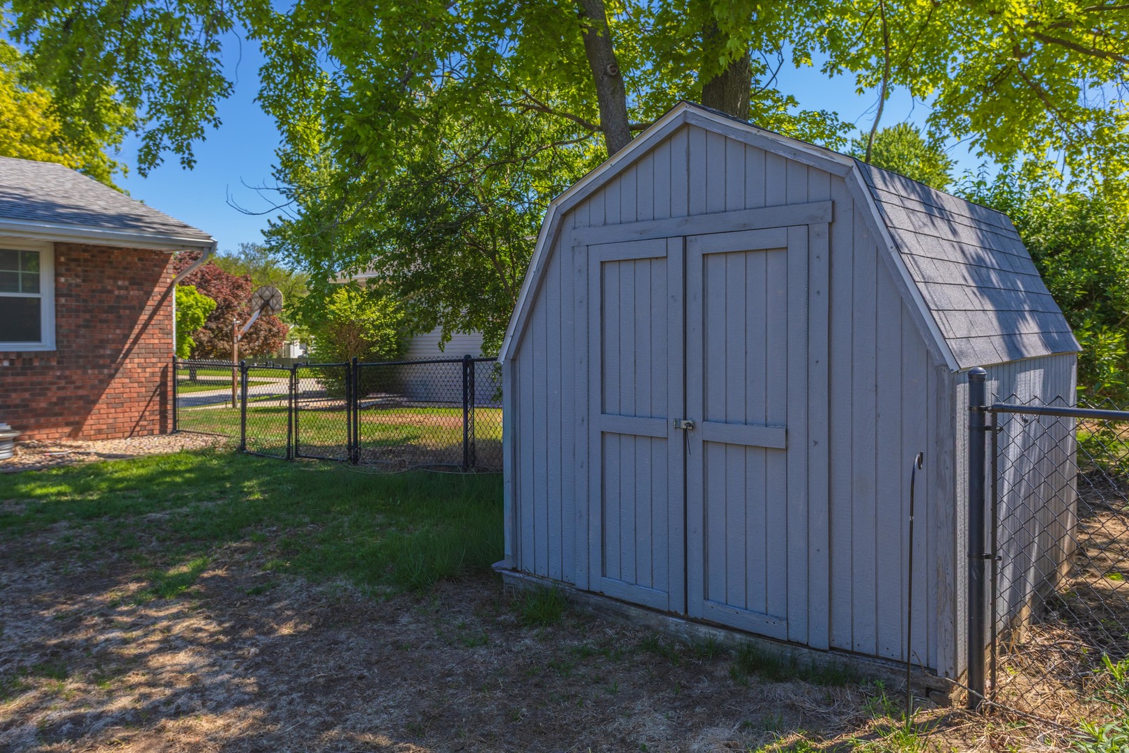 1717 Cook Drive Normal, IL 61761 - Photo 43 of 55 a view of a small house in front of a yard with wooden fence and plants