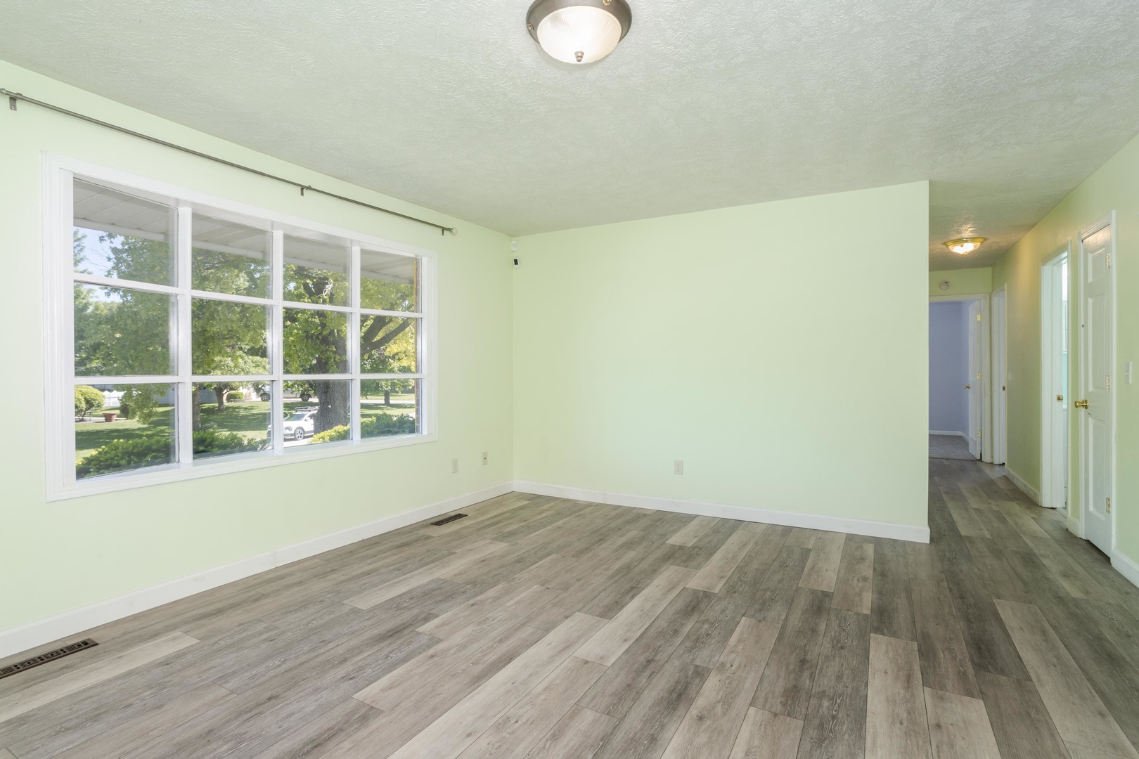 1717 Cook Drive Normal, IL 61761 - Photo 5 of 55 a view of an empty room with wooden floor and a window