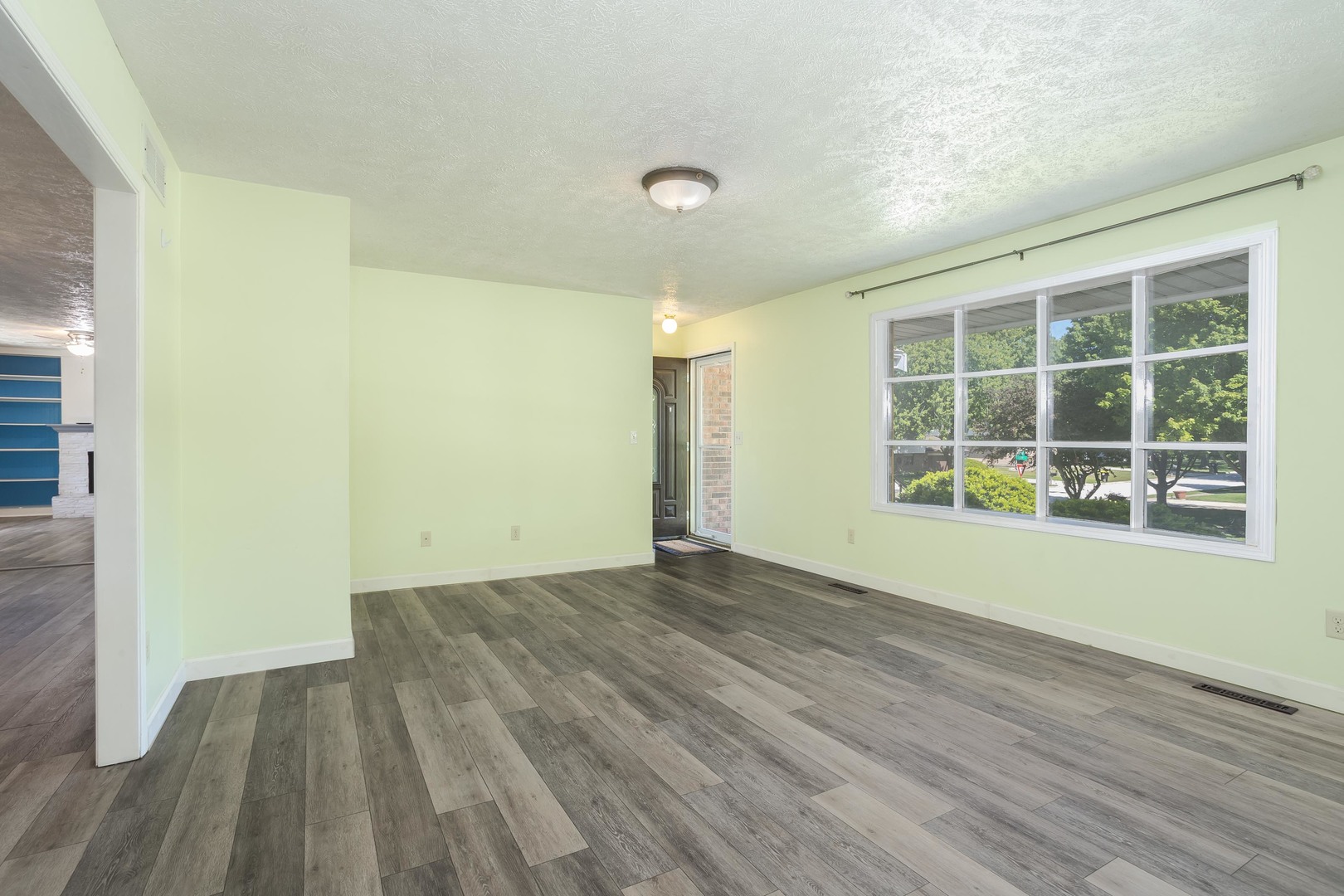 1717 Cook Drive Normal, IL 61761 - Photo 6 of 55 a view of an empty room with wooden floor and a window