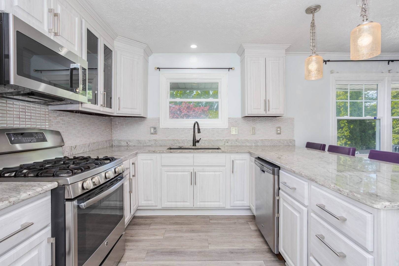 1717 Cook Drive Normal, IL 61761 - Photo 8 of 55 a kitchen with stainless steel appliances granite countertop a sink stove a oven a sink dishwasher and cabinets with wooden floor